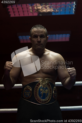 Image of kick boxer with his championship belt