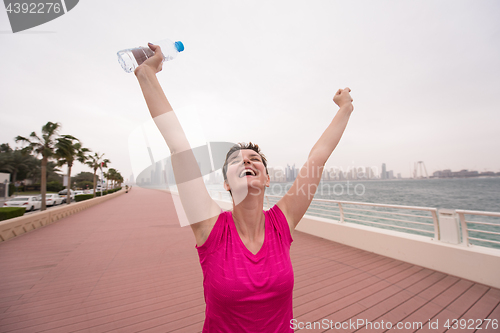 Image of young woman celebrating a successful training run