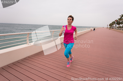 Image of woman busy running on the promenade