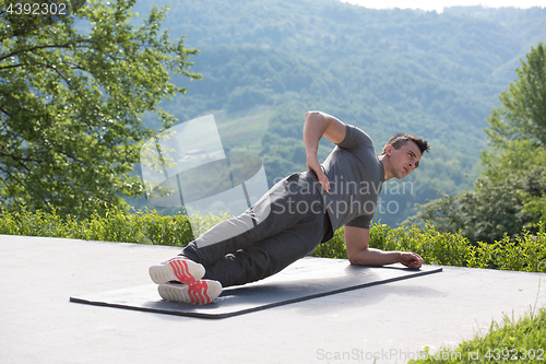 Image of man doing morning yoga exercises