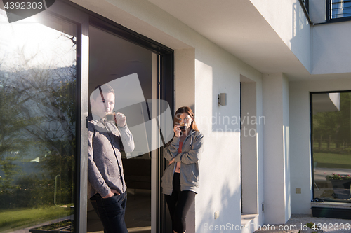 Image of couple enjoying on the door of their luxury home villa