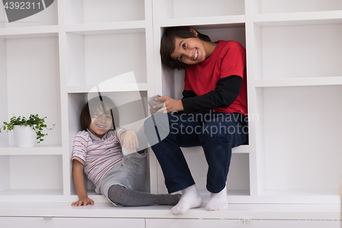 Image of young boys posing on a shelf