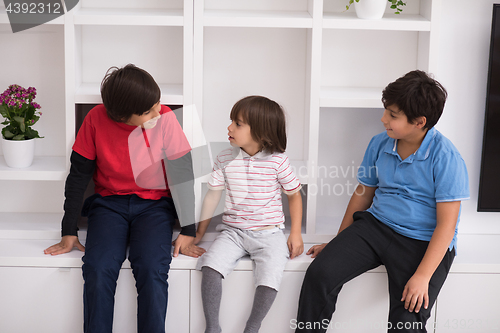 Image of young boys posing on a shelf