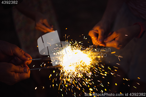 Image of Anonymous person with burning firework