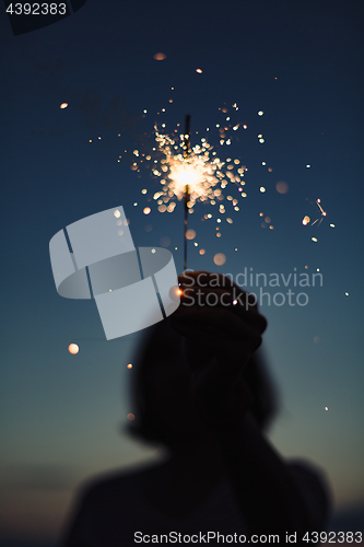 Image of Anonymous person with burning firework