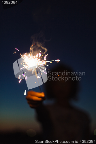 Image of Anonymous person with burning firework