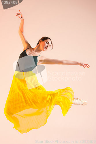 Image of Young and incredibly beautiful ballerina is dancing at studio