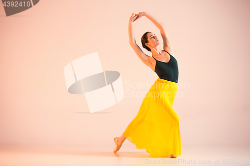 Image of Young and incredibly beautiful ballerina is dancing at studio