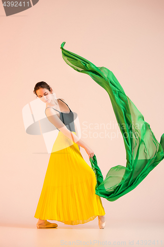 Image of Young and incredibly beautiful ballerina is dancing at studio