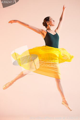 Image of Young and incredibly beautiful ballerina is dancing at studio