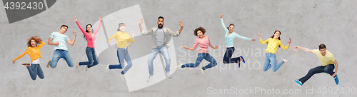 Image of happy people or friends jumping in air over gray