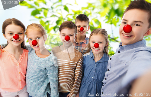 Image of happy childre taking selfie at red nose day