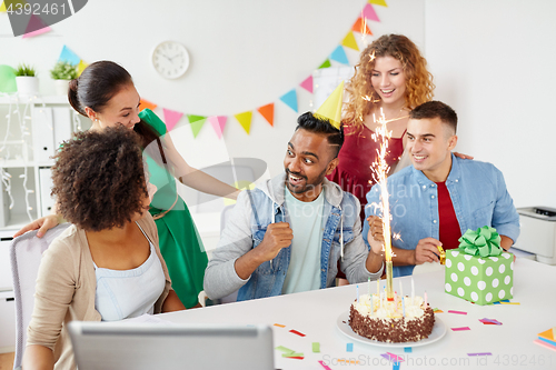 Image of office team greeting colleague at birthday party