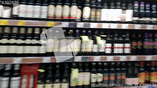 Image of Blurred wine bottles on shelf