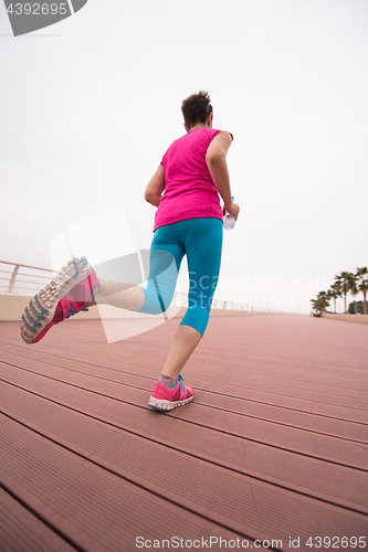 Image of woman busy running on the promenade