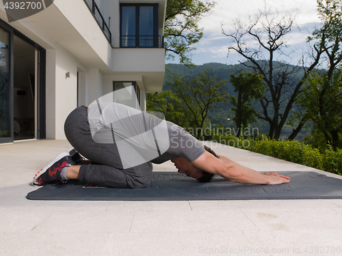 Image of man doing morning yoga exercises
