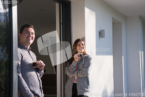 Image of couple enjoying on the door of their luxury home villa