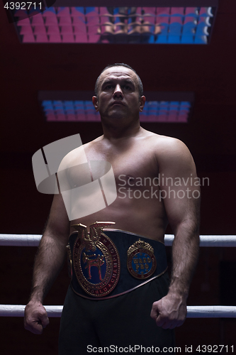 Image of kick boxer with his championship belt