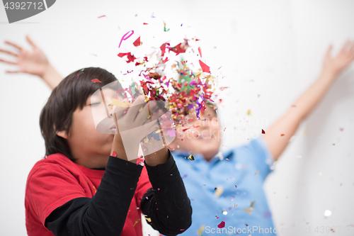 Image of kids  blowing confetti