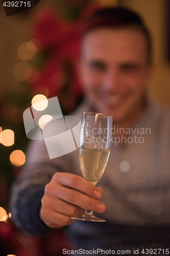 Image of Happy young man with a glass of champagne