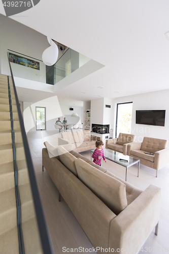 Image of family with little girl enjoys in the modern living room