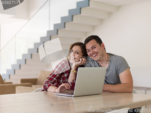 Image of happy young couple buying online