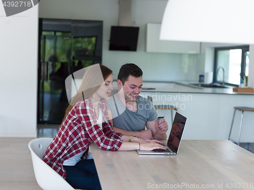 Image of happy young couple buying online