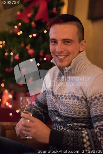 Image of Happy young man with a glass of champagne