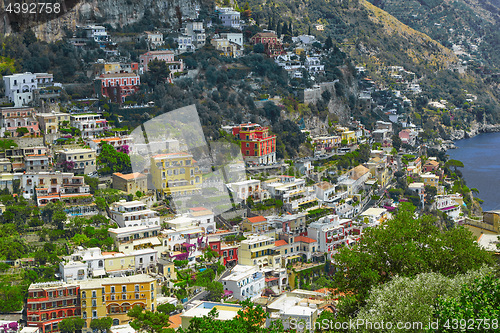 Image of One of the best resorts of Italy with old colorful villas on the steep slope, nice beach, numerous yachts and boats in harbor and medieval towers along the coast, Positano.