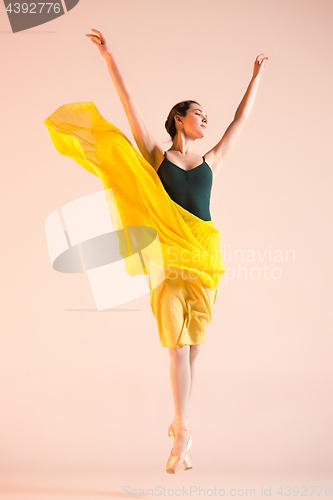 Image of Young and incredibly beautiful ballerina is dancing at studio