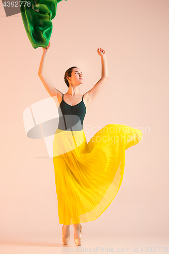 Image of Young and incredibly beautiful ballerina is dancing at studio