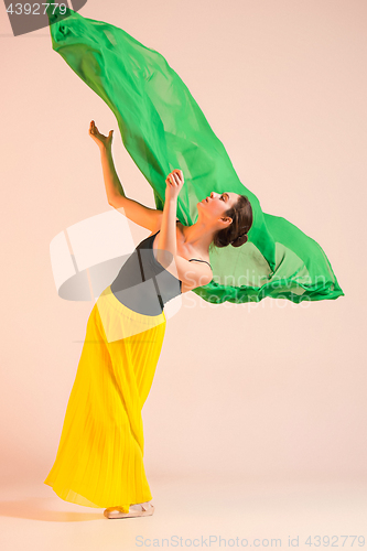 Image of Young and incredibly beautiful ballerina is dancing at studio