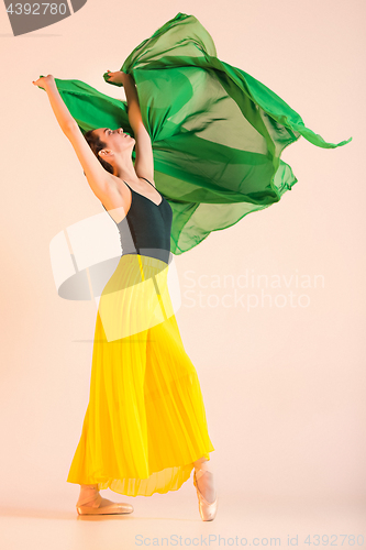 Image of Young and incredibly beautiful ballerina is dancing at studio