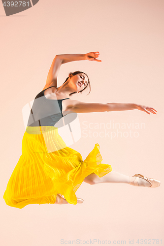 Image of Young and incredibly beautiful ballerina is dancing at studio