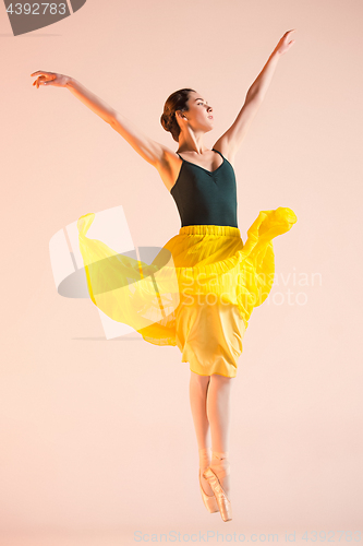 Image of Young and incredibly beautiful ballerina is dancing at studio