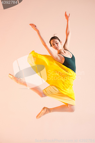 Image of Young and incredibly beautiful ballerina is dancing at studio