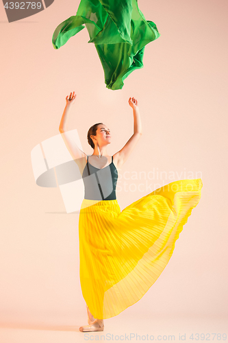 Image of Young and incredibly beautiful ballerina is dancing at studio