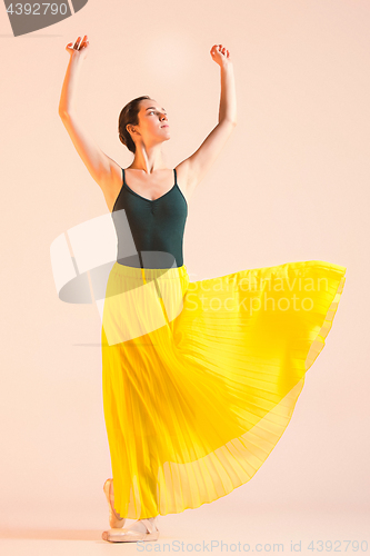 Image of Young and incredibly beautiful ballerina is dancing at studio