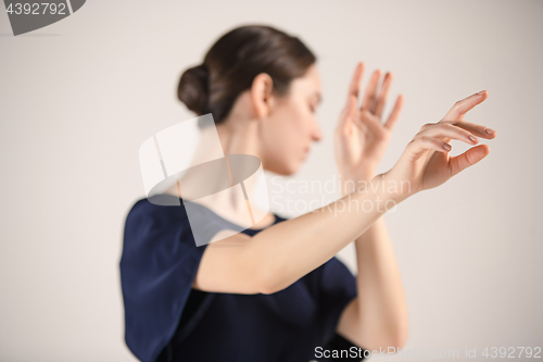 Image of Young and incredibly beautiful ballerina is dancing at studio