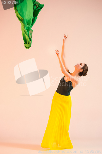 Image of Young and incredibly beautiful ballerina is dancing at studio