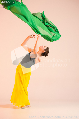 Image of Young and incredibly beautiful ballerina is dancing at studio