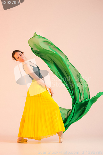 Image of Young and incredibly beautiful ballerina is dancing at studio