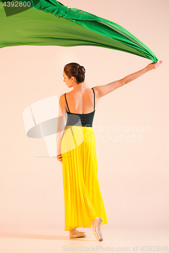 Image of Young and incredibly beautiful ballerina is dancing at studio