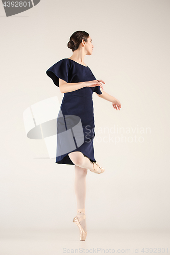 Image of Young and incredibly beautiful ballerina is dancing in a blue studio