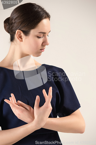 Image of Young and incredibly beautiful ballerina is dancing at studio