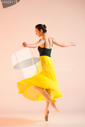 Image of Young and incredibly beautiful ballerina is dancing at studio