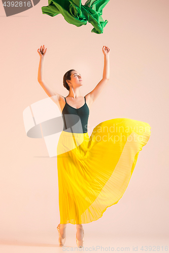 Image of Young and incredibly beautiful ballerina is dancing at studio