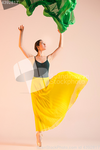 Image of Young and incredibly beautiful ballerina is dancing at studio