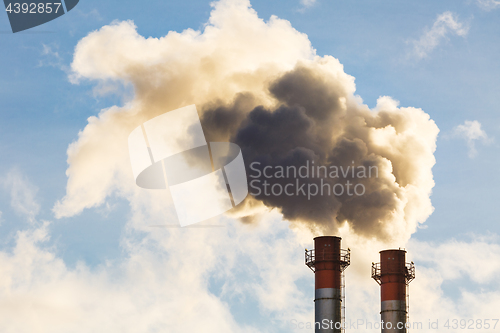 Image of Stream of dark smoke from the chimney of factory