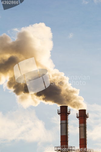 Image of Stream of dark smoke from the chimney of factory